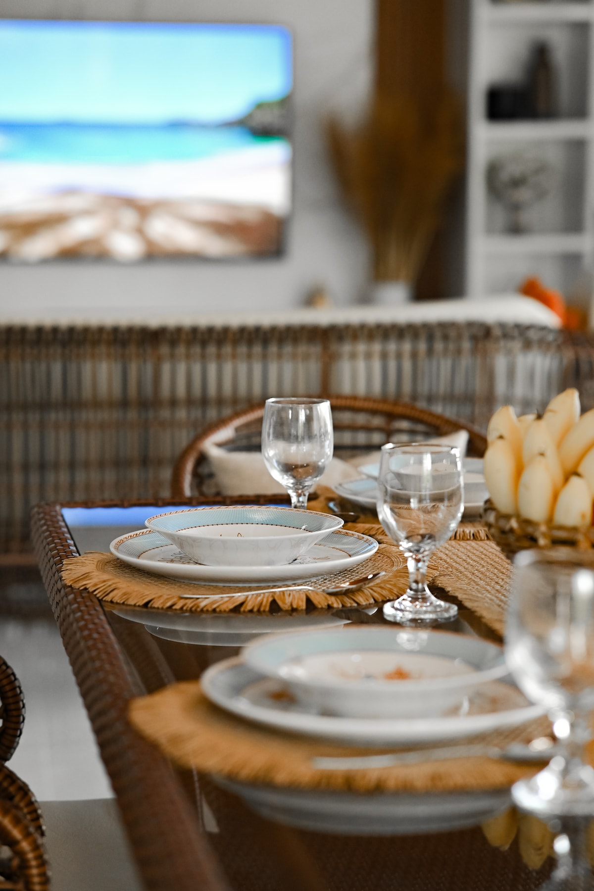 Elegant table setting with rattan chairs and smart TV